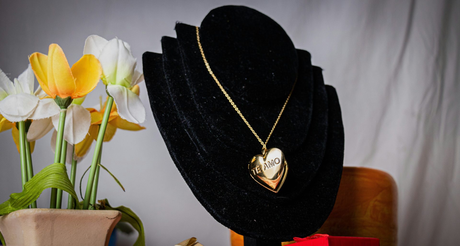 a black hat with a gold heart pendant on it